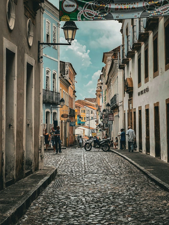 a cobblestone street with a motorcycle parked on the side